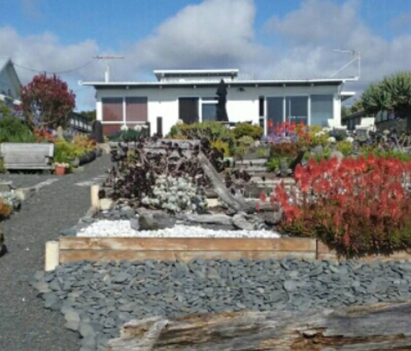 View of house from beach, with the upstairs unit just showing.