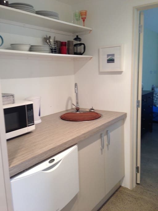 Private use of kitchenette with sink, dishwasher, microwave and plug in cooking appliances.