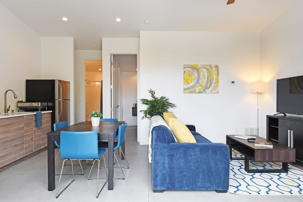 The main room is an open concept with dining space and a queen size memory foam sleeper sofa. The 55" smart TV will make your time at "home" enjoyable.
