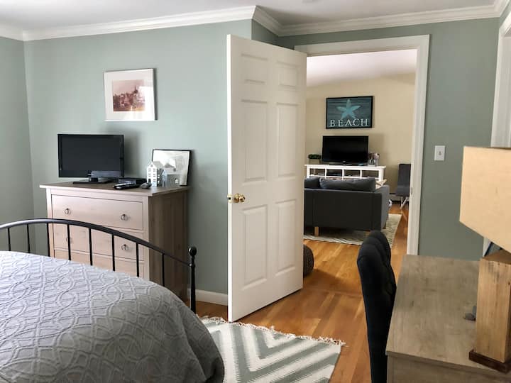 غرفة نوم مع مكتب ومكتب يطل على غرفة المعيشة