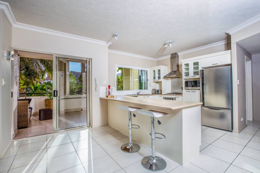 Fully-equipped kitchen opens to a large balcony