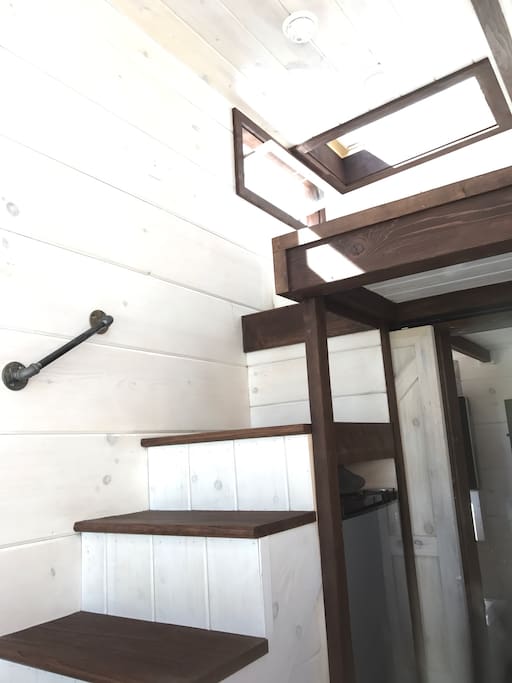 Stairs to the loft with a memory foam Queen size memory bed. Skylight over the bed where you can fall asleep under the stars.