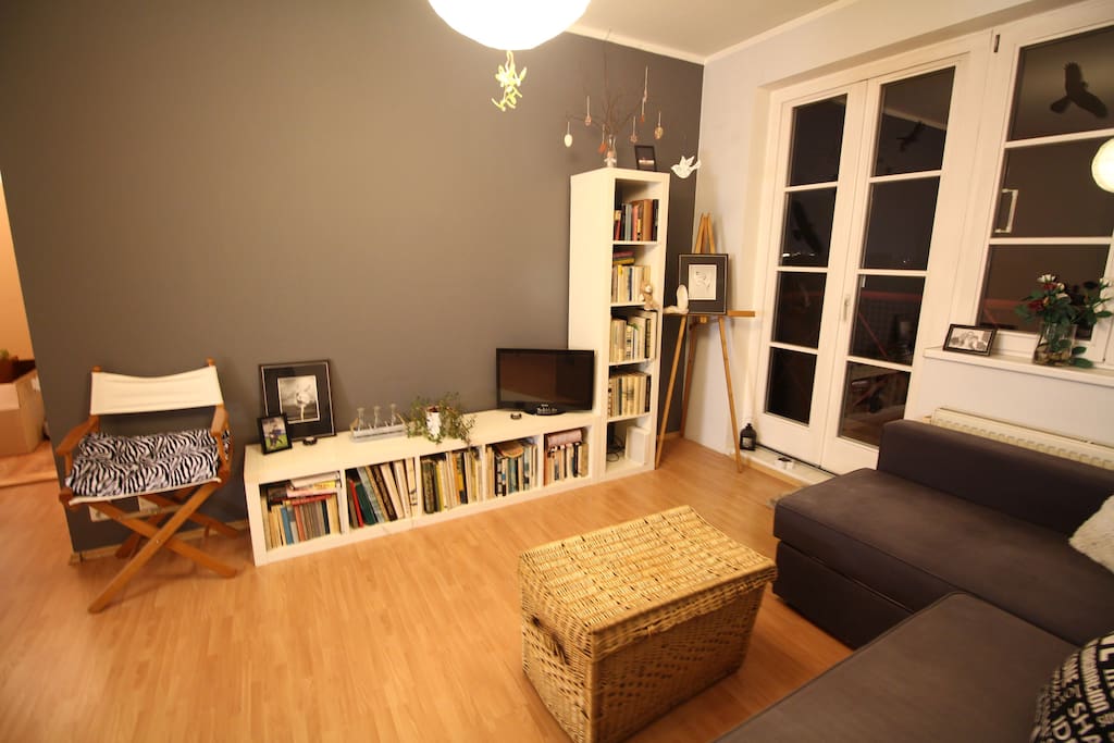 Living room with small TV and balcony entrance