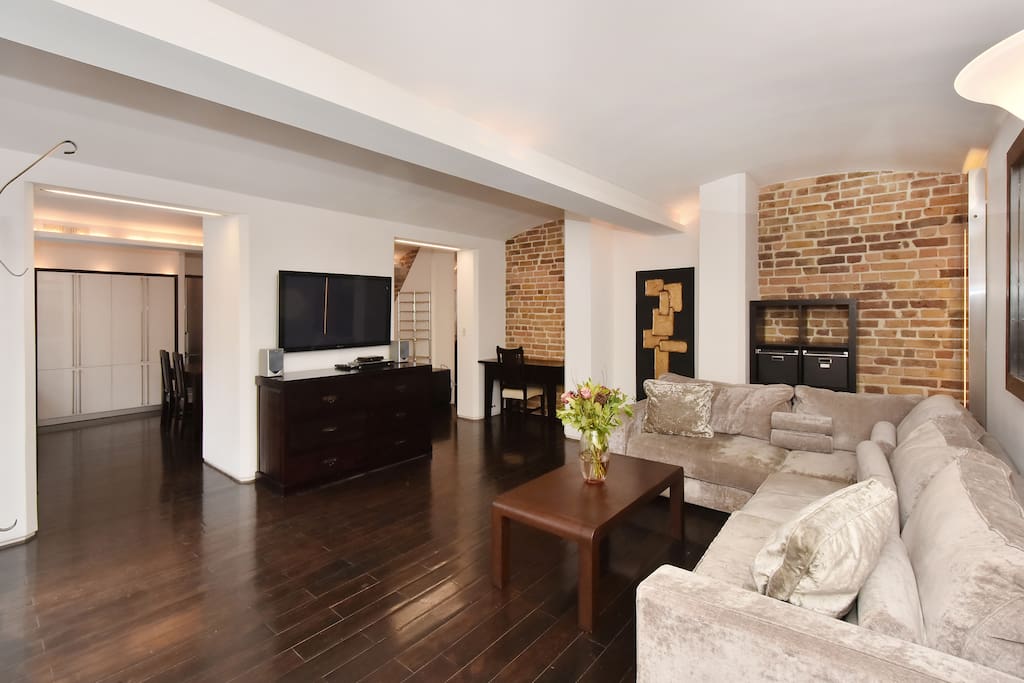 The chic, elegant and spacious Lounge with kitchen and dining area beyond