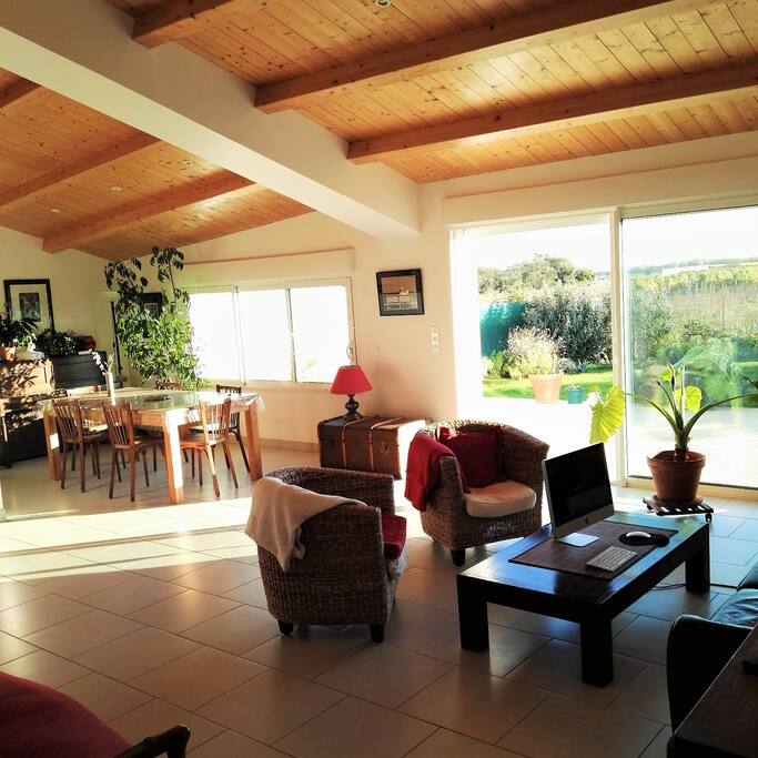 Living and dining room with a direct access to the terrace and garden