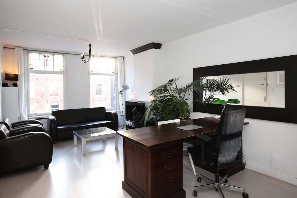 Office desk with electricity and WiFi. Spacious living room with big screen cable TV.