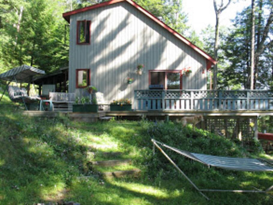 Cheerful cottage surrounded by large deck