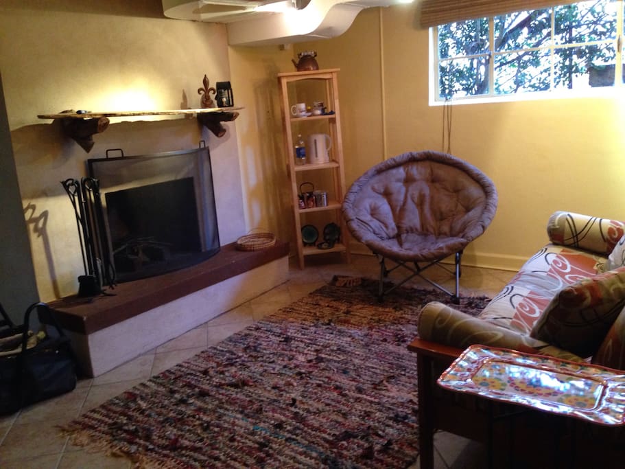 Living space with wood burning fireplace, conversation area, futon couch