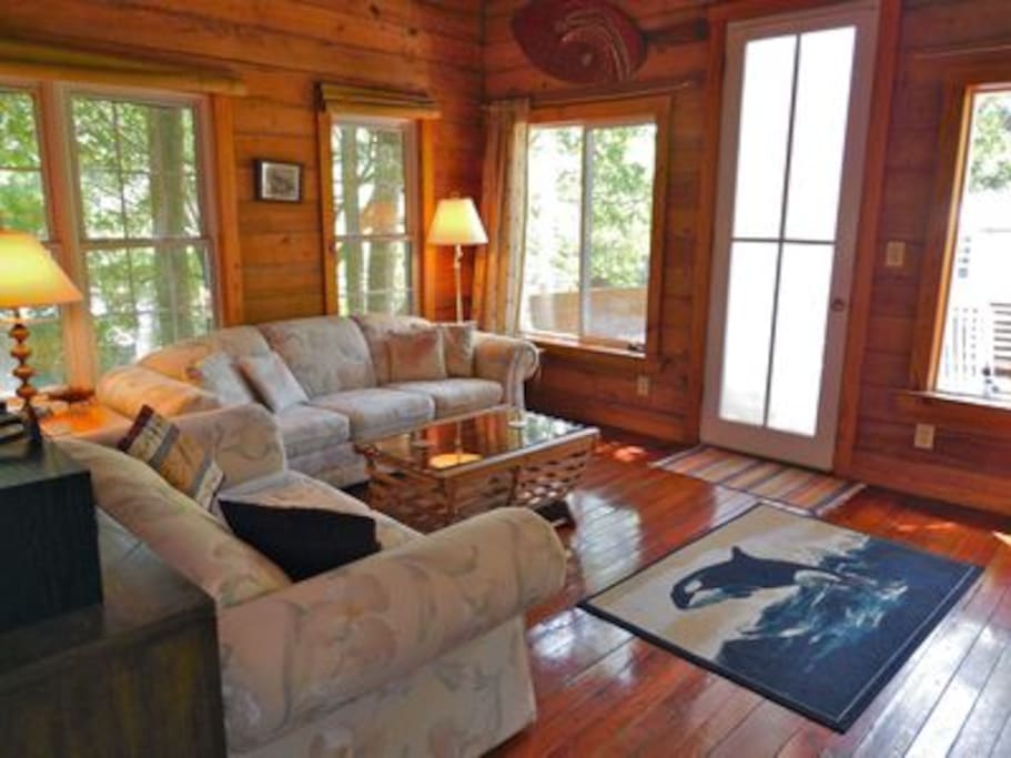 Spacious living area with door leading to the front deck