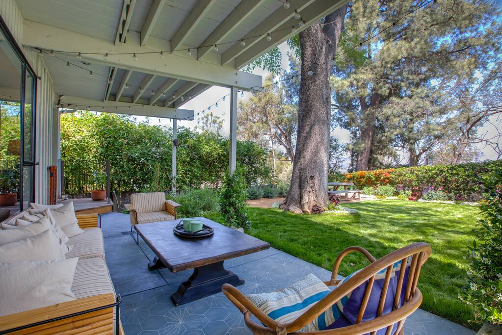 Enjoy chit-chat at a sitting area on the backyard patio.