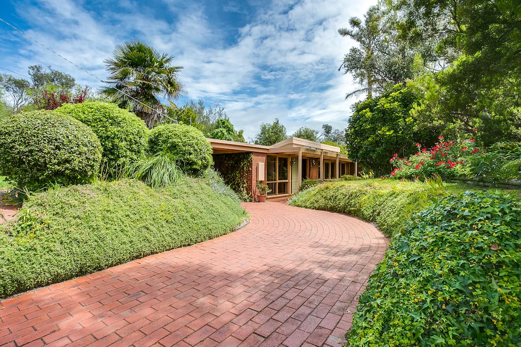 Set back in lush gardens