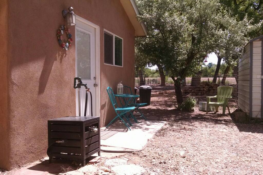 Plenty of outdoor seating for relaxing and enjoying our New Mexico climate: guests have the bistro set on the front stoop, now with porch, plus a pair of Adirondack chairs and side table under the shady Russian Olive tree. Casita also has a fenced private side yard with another Adirondack chair with side table therein.