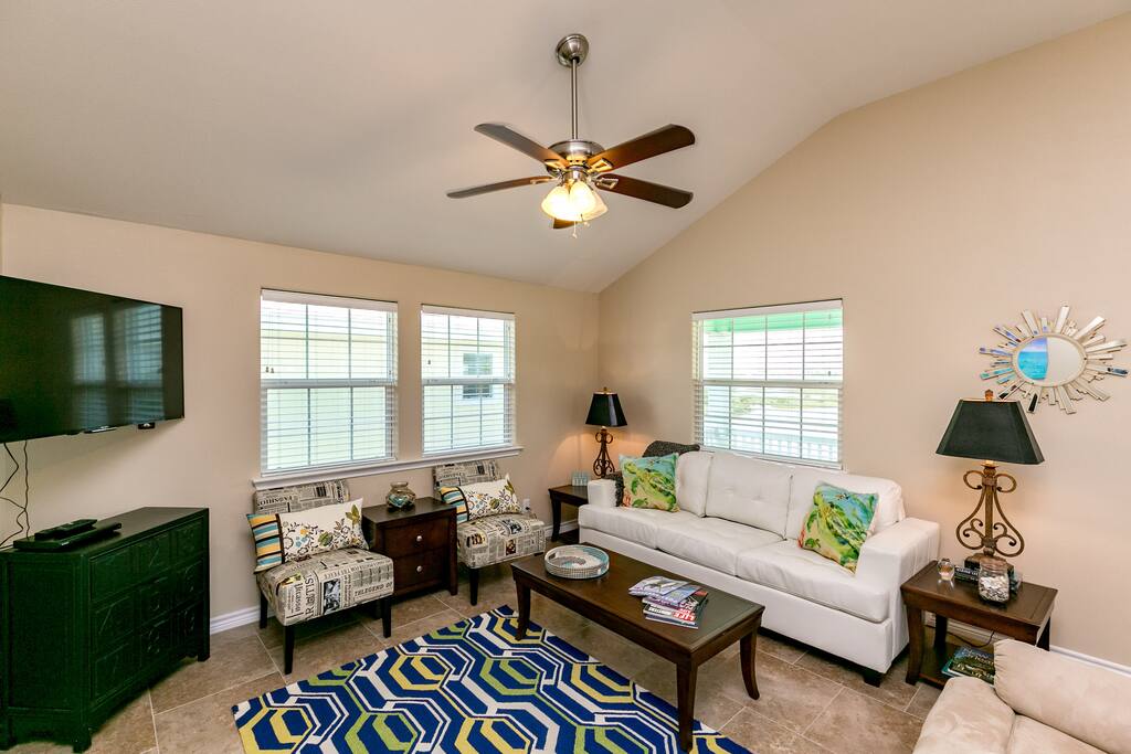 This airy home has upscale coastal decor and vaulted ceilings.