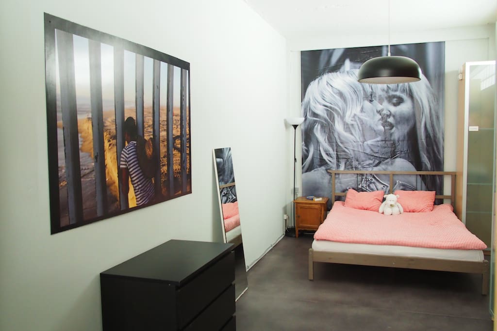 The bedroom with a king size bed and wardrobes.