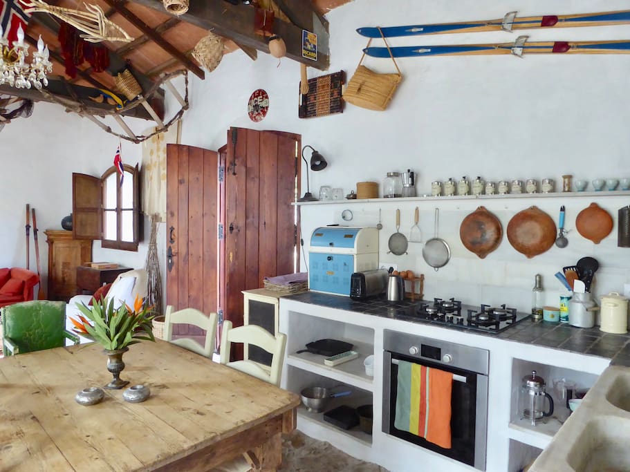 Large open plan kitchen / sitting room opening onto bouganvillea-filled courtyard
