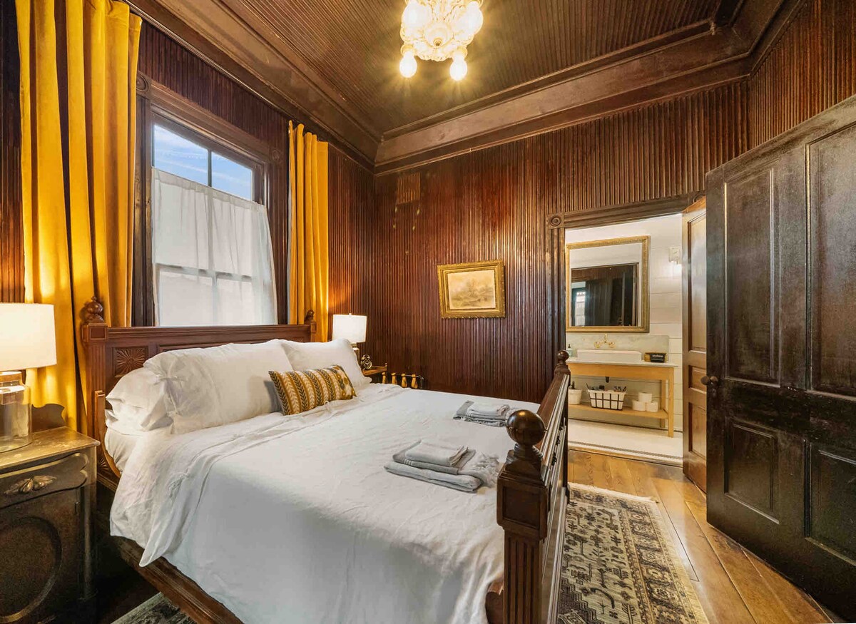 Master bedroom. This room has blackout curtains and gets very dark for light sleepers. This room has attached ensuite bathroom with shower. Wall mounted ceiling fan for added comfort. Some doors lead into front room but they are easily closed. 