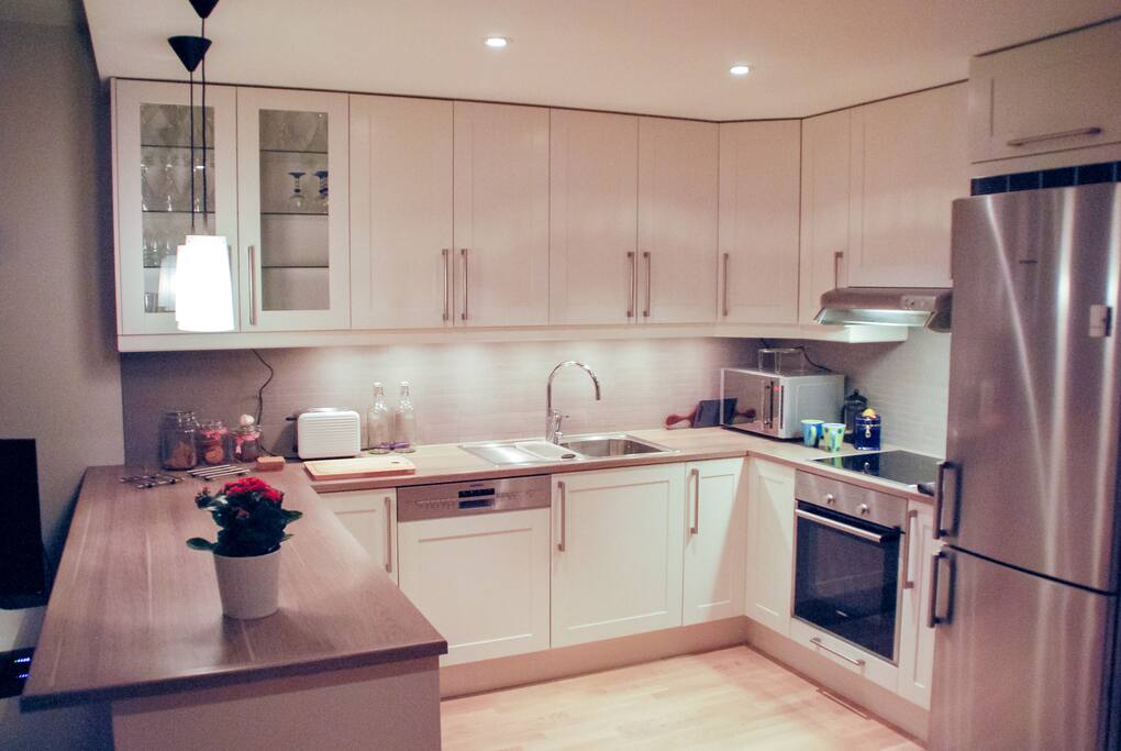 Spacious, open kitchen with modern appliances including microwave and dishwasher.