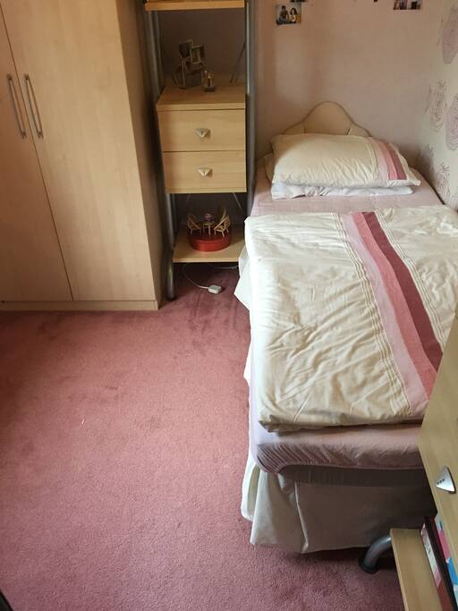 Single room with a single bed with a desk and chair