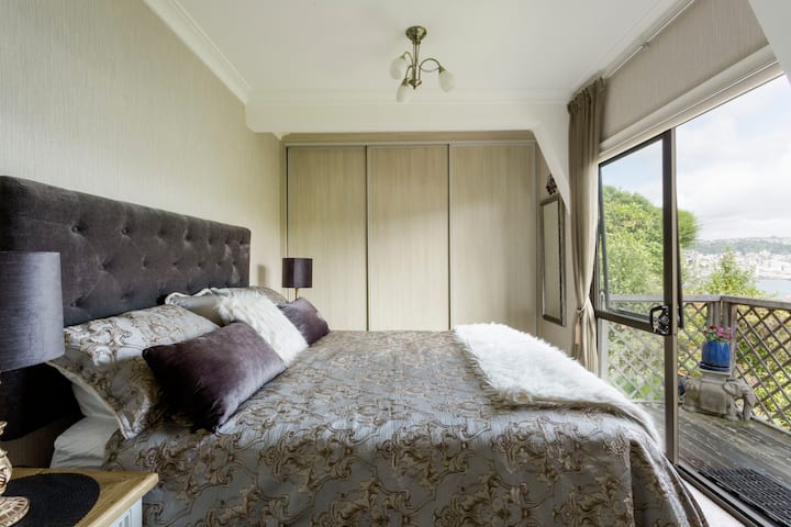 Master bedroom with doors opening onto private deck. Comfortable king size bed. Wake up to the view  