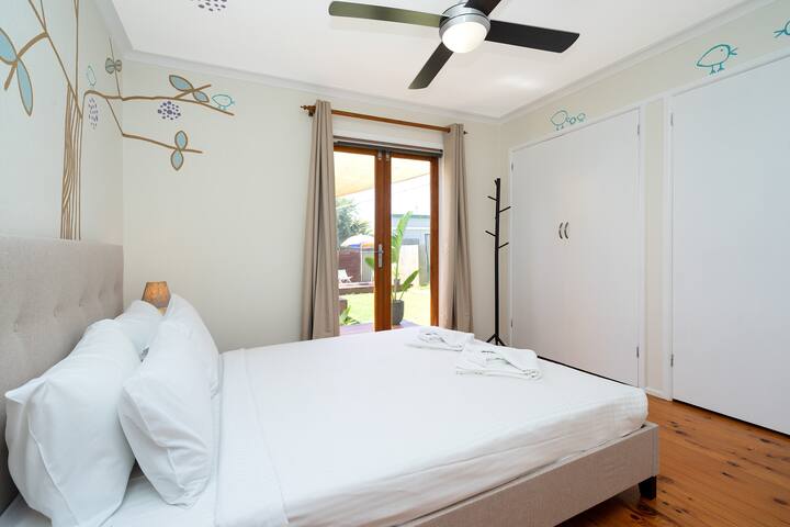 One bedroom features a queen bed dressed in hotel quality linen, in-built wardrobes and access to the garden