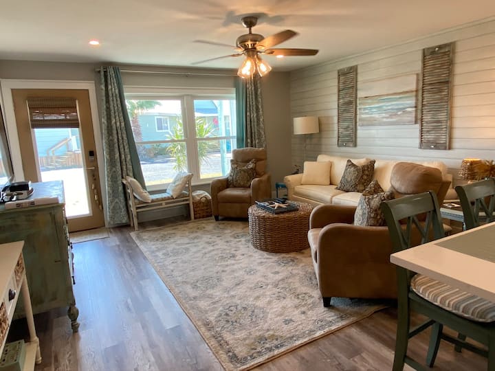 Gorgeous, comfortable & coastal themed living room decor. Features an Ethan Allen queen pull out sofa bed with a very comfortable mattress & the chairs are recliners.