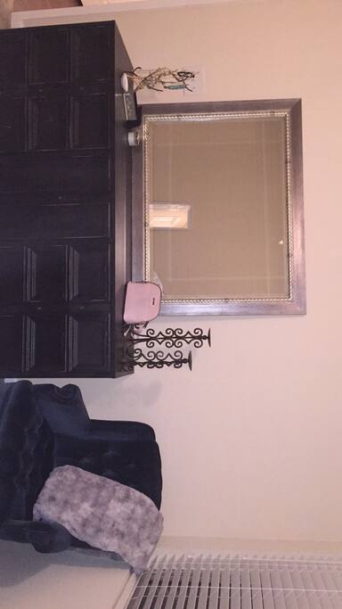 Dresser, mirror and comfortable chair.
