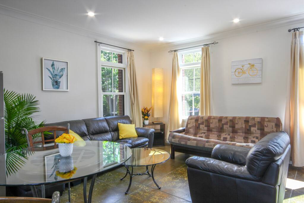 Living room; cathedral ceilings, dimming pot lights, futton sofa bad, leather couch set, glass top tables.