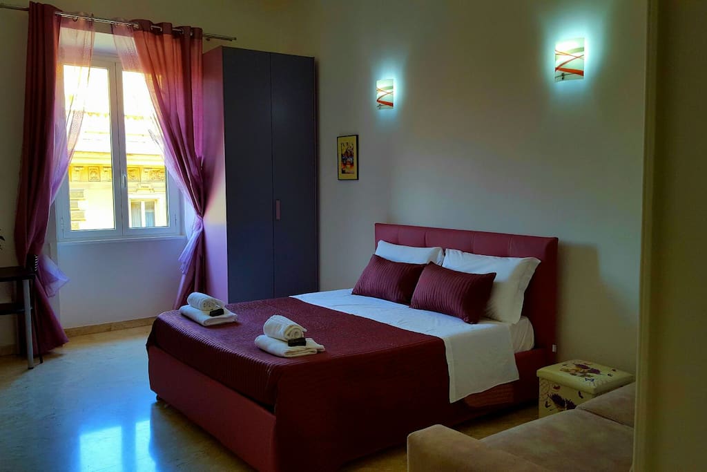 Room "Violet" with double king size bed, double sofa bed, TV, closet and desk