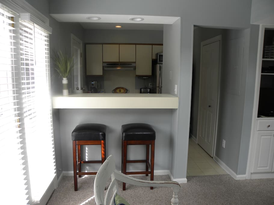 Small but fully equipped kitchen with washer/dryer in closet to the right.