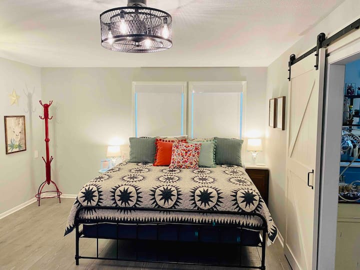 A comfy king bed with two night stands is in the master bedroom. The caged light/fan puts out tons of air! The cordless shades are dual layer:  one is light blocking, and the second layer light filtering. 