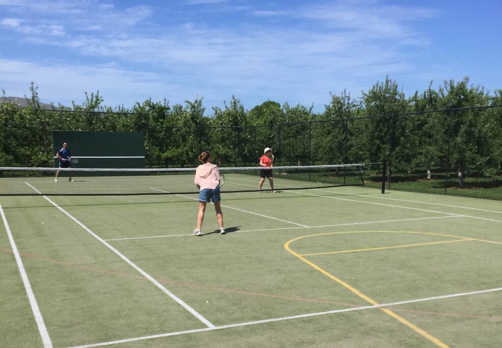 All weather tennis court and basketball backboard