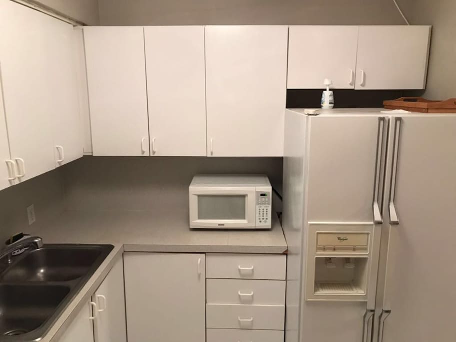There are Microwave, stove, refrigerator, coffee maker, toaster, air fry and dishes.