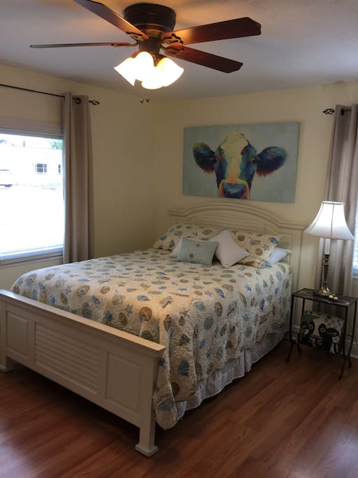 Master bedroom is decorated with original art and a queen size bed with pillow top. Cedar lined closets and flat screen tv.