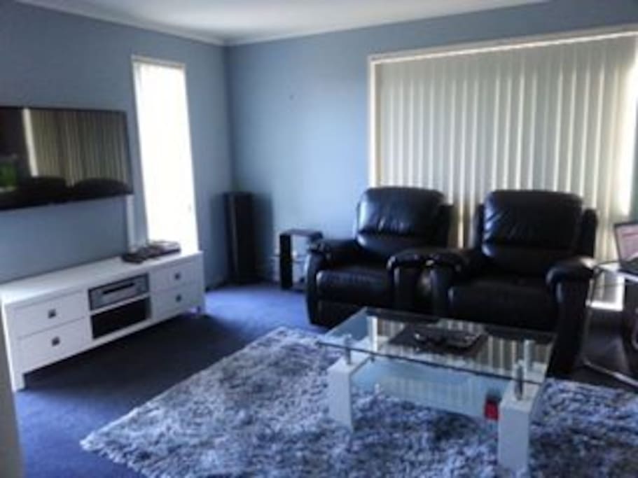 Comfortable lounge with leather couches and big screen TV