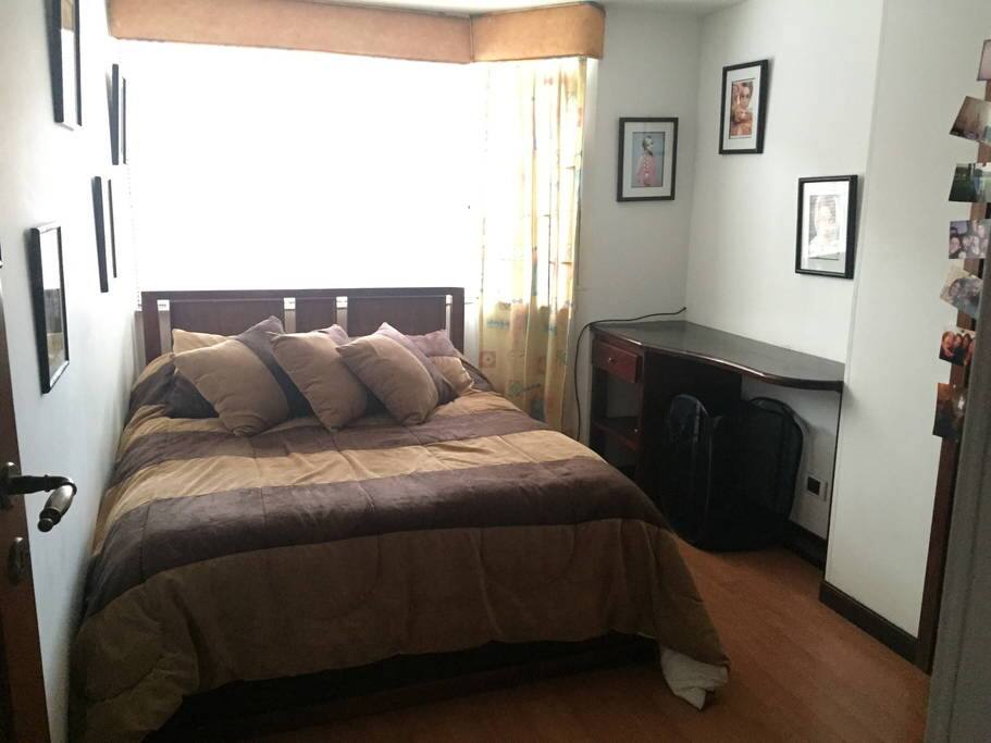 Bedroom with double bed and desk