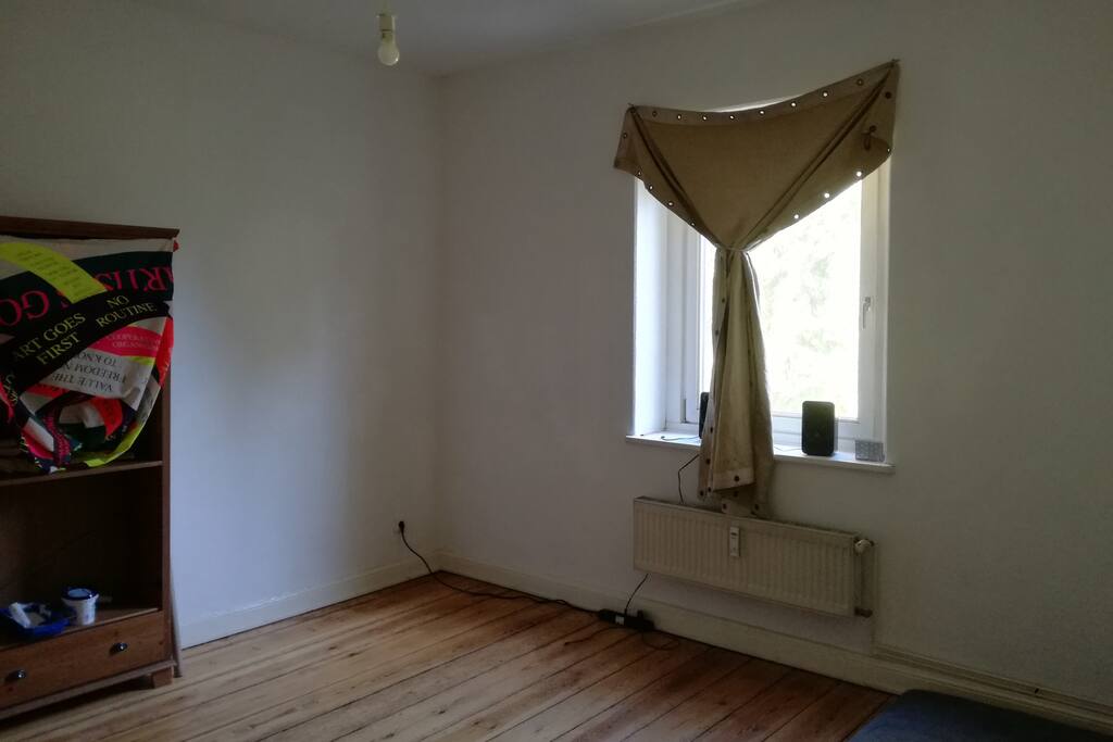 This is your 17m² room. It has a window where the sunlight gets through in the morning, a wardrobe and a 200x90cm bed. You can use this room as your private room.