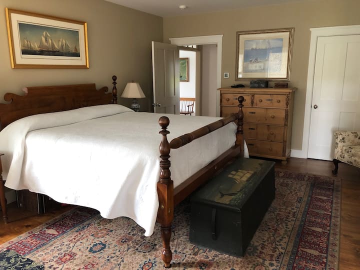 A view of the first floor master bedroom looking toward the hallway.  The bed in the first floor master is a king.