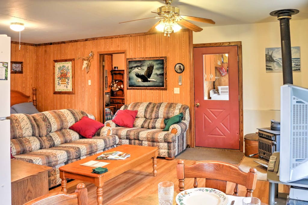 This open living area features 2 couches and a large TV.