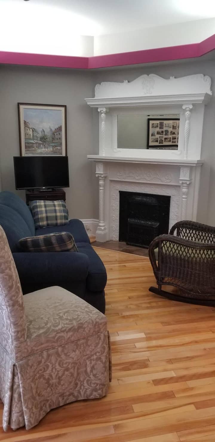 living room with decorative original fireplace mantel
