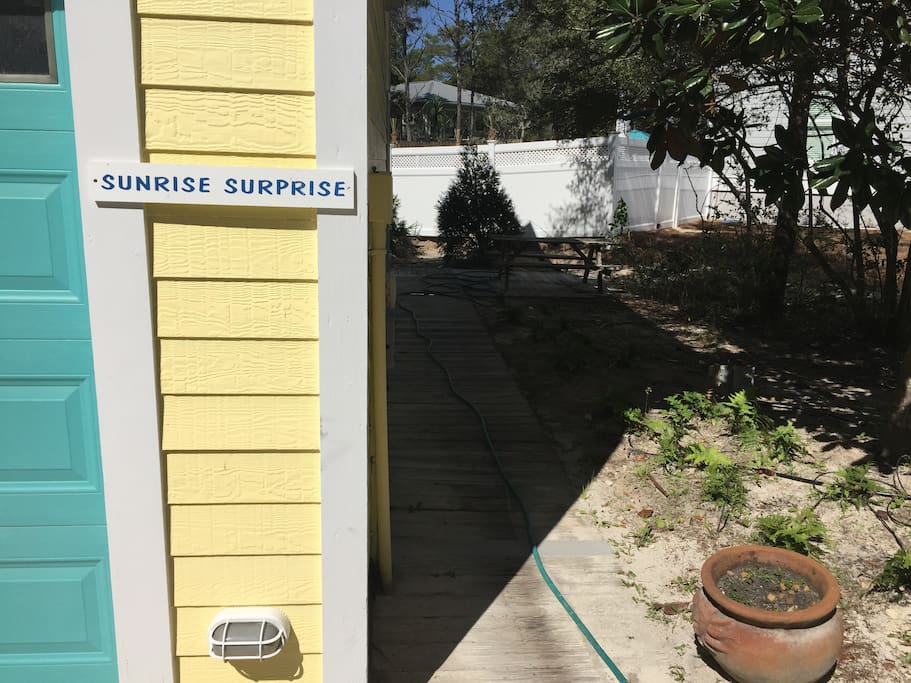 Side path from parking area leads down to the rear entry stairway.