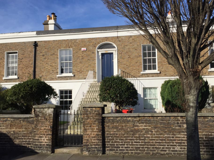 Frontal view of the house. The flat is the larger, lower half