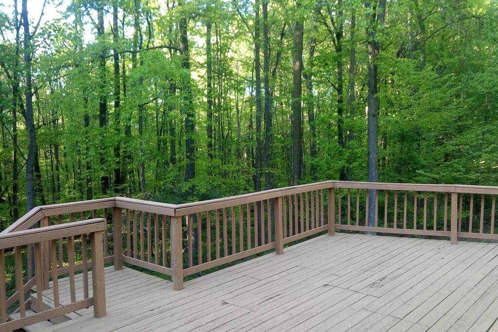 This is the rear deck overlooking the serene wooded property