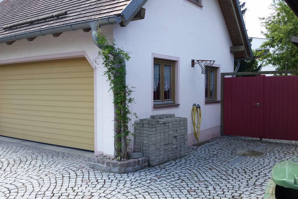 Your parking spot right beside the garage, in front of the red gate.