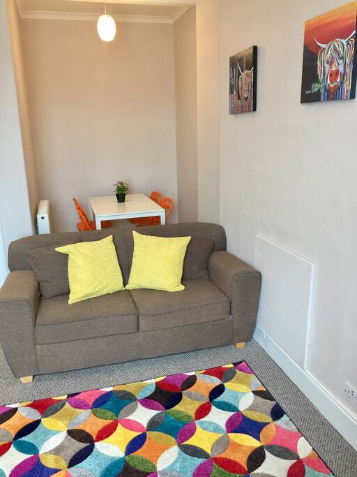 The living room with sofa bed and dining recess.