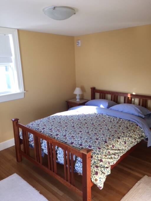 Bedroom with queen size bed, dresser and spacious closet