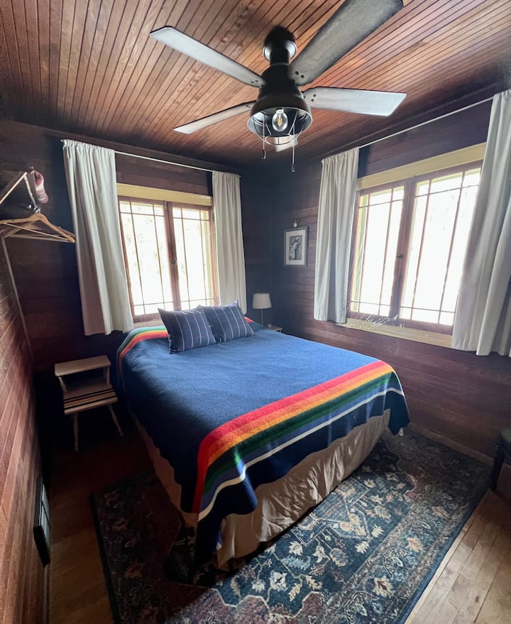 Main floor bedroom with queen bed. 