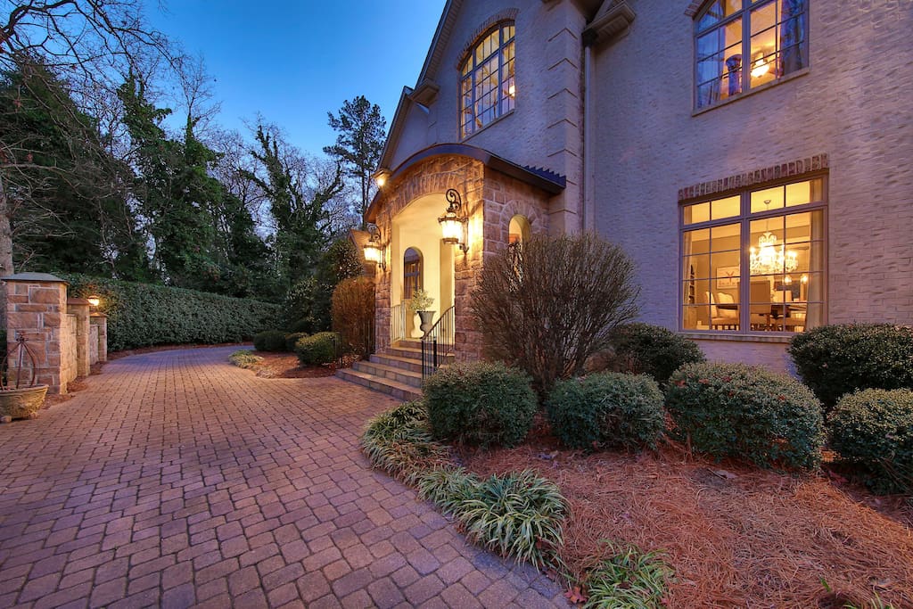 Front of house and driveway that leads to 4 car garage in back.