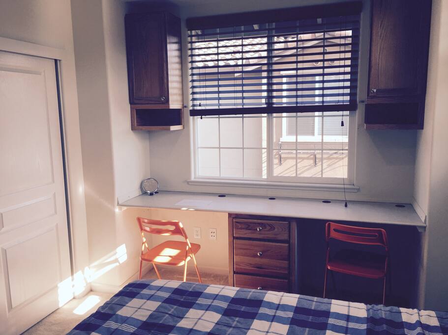 Two desks and closet in bedroom