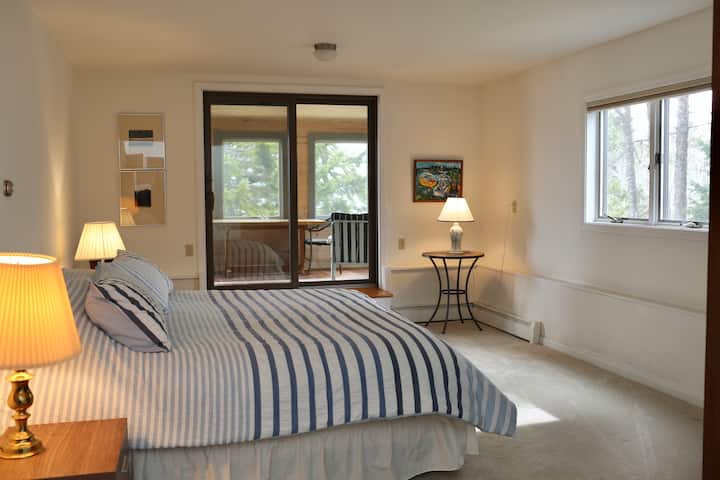 Ground floor bedroom; king-sized bed with ensuite bathroom and private, enclosed porch.