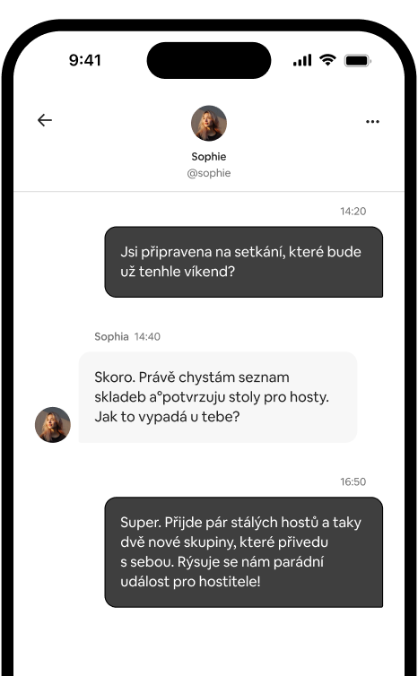 Telefon zobrazující vlákno soukromých zpráv mezi dvěma hostiteli, kteří koordinují setkání.